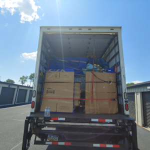 A Prime Moving Center truck loaded with boxes and furniture, ready for transport in Pittsburgh, PA.