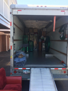 A moving truck with its ramp down, partially loaded with wrapped furniture and boxes by Wright-A-Way Transportation Services in Cary, NC.