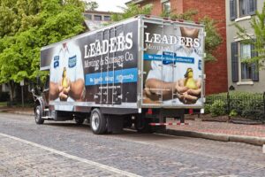 A branded Leaders Moving & Storage Co. truck parked on a cobblestone street in Indianapolis, IN.