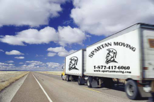 A large moving truck traveling on a highway, representing long-distance moving services by Movers-Moving.NET in Concord, CA.