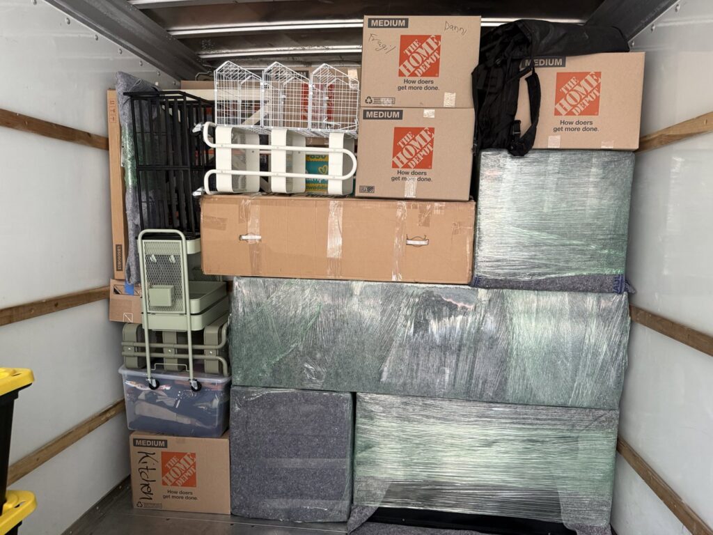 The interior of a moving truck expertly packed with boxes and wrapped furniture by Packsen Moving in San Antonio, TX.