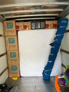Inside a moving truck, efficiently packed with boxes and a mattress by Gifted Hands Moving & Storage in Collierville, TN.