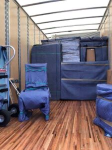 The interior of a moving truck fully packed with furniture wrapped in protective blankets and plastic by Miracle Movers of Charleston, SC in Summerville, SC.