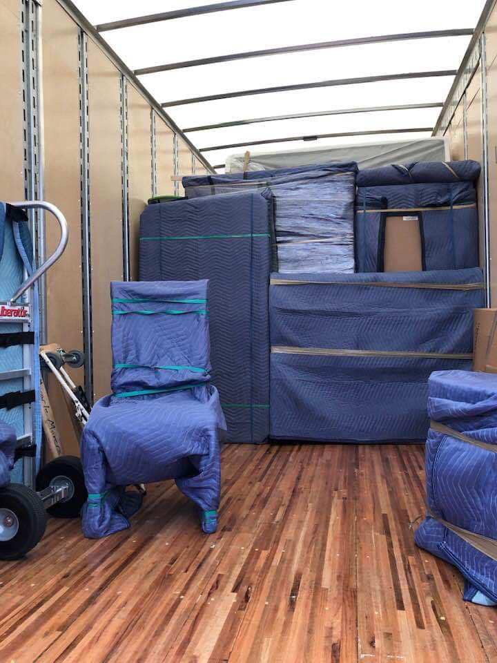 The interior of a moving truck fully packed with furniture wrapped in protective blankets and plastic by Miracle Movers of Charleston, SC in Summerville, SC.