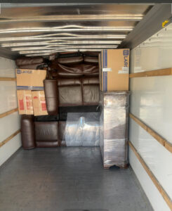 A moving truck interior fully packed with wrapped furniture and boxes by Advantage Express Movers in Arlington, TX.