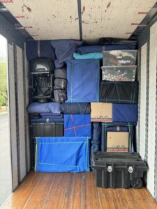 A moving truck efficiently packed with various household items and bins by Moving Marvels in Tucson, AZ.