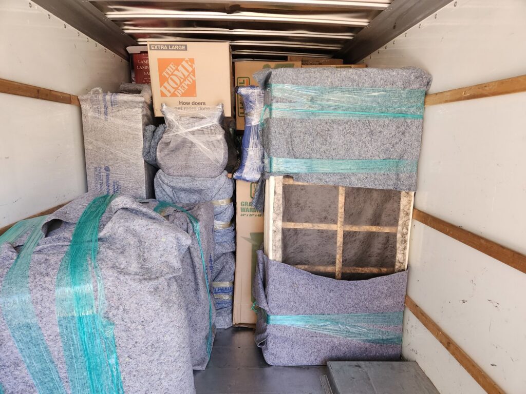 Interior of a moving truck fully packed with carefully wrapped furniture and boxes by Az Student Movers in Scottsdale, AZ