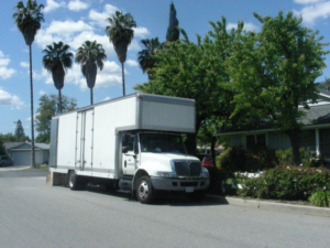 A white moving truck from Movers-Moving.NET parked on a residential street in Concord, CA, ready for a local move.