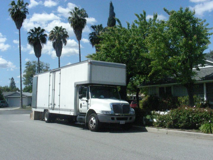 A white moving truck from Movers-Moving.NET parked on a residential street in Concord, CA, ready for a local move.