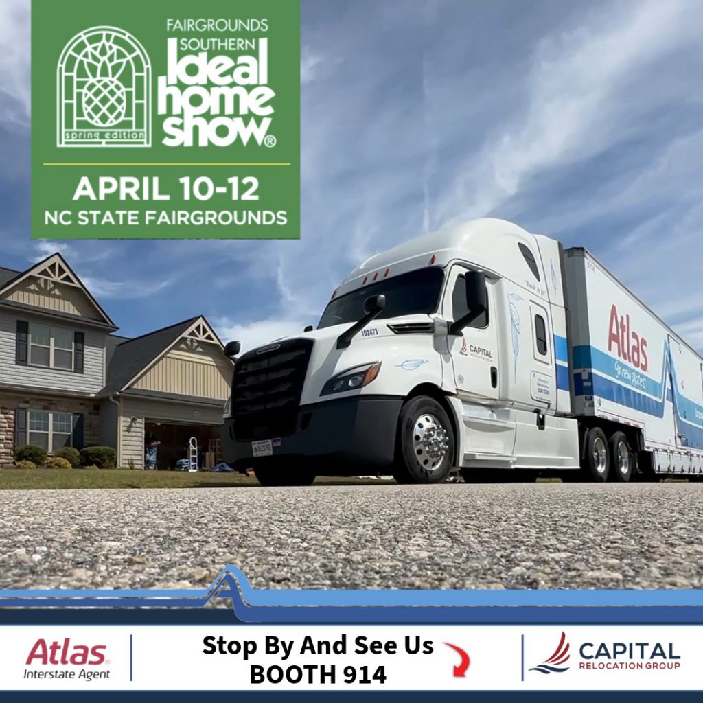 A large Capital Relocation Group moving truck parked in front of a residential home in Raleigh, NC.
