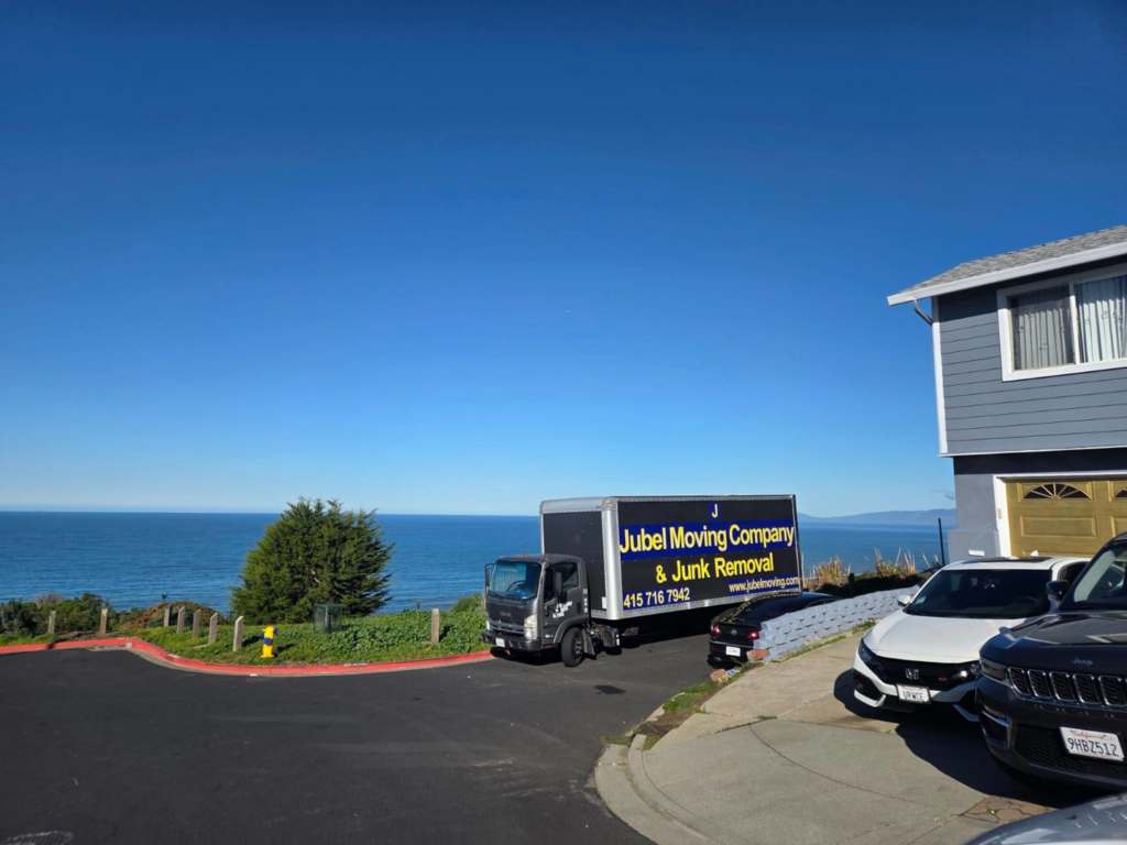 A Jubel Company LLC moving truck parked near a residential house with an ocean view in San Francisco, CA.