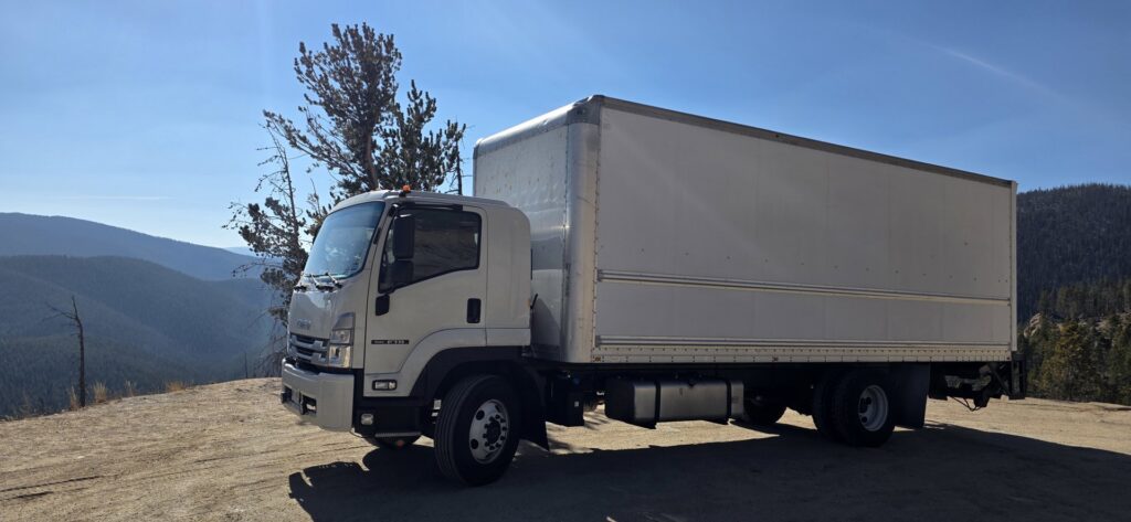 A white moving truck parked on a scenic overlook, representing services by Emanuel Movers, Inc. in Houston, TX