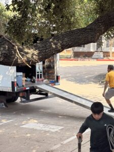 A moving truck with its ramp extended, ready for loading or unloading, with movers nearby from Houston Affordable Movers in Houston, TX.