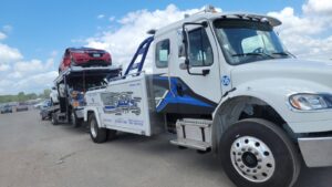 A multi-car carrier tow truck from Allan Motors & Wrecker Service LLC transporting several vehicles in Houston, TX
