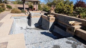 A multi-level pool under renovation, showing exposed aggregate finish and steps by Fix A Pool in Las Vegas, NV