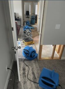 Multiple industrial air movers and drying equipment deployed across a room to mitigate water damage, a service provided by Standard Restoration in Salt Lake City, UT.