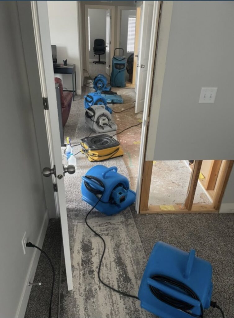 Multiple industrial air movers and drying equipment deployed across a room to mitigate water damage, a service provided by Standard Restoration in Salt Lake City, UT.
