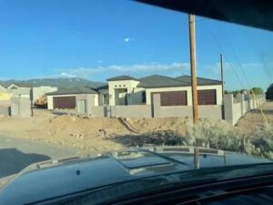 Multiple brown garage doors installed on a new construction home by Quality-Brand Garage Doors in Rio Rancho, NM.