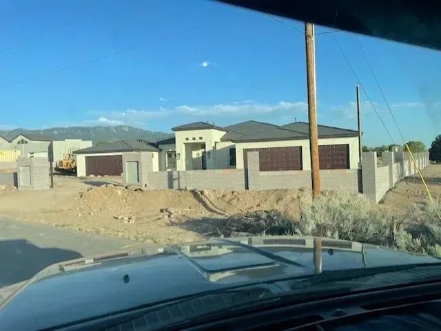 Multiple brown garage doors installed on a new construction home by Quality-Brand Garage Doors in Rio Rancho, NM.