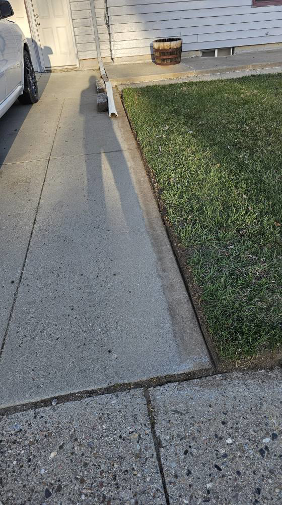 A neatly edged lawn alongside a sidewalk, demonstrating precise lawn care by Matt's Lawn Service in Casper, WY.
