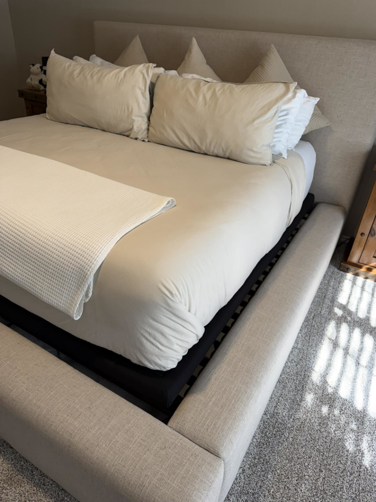 A neatly made bed with clean bedding and a tidy bedroom, reflecting the quality service of Lupita's cleaning services in San Antonio, TX.