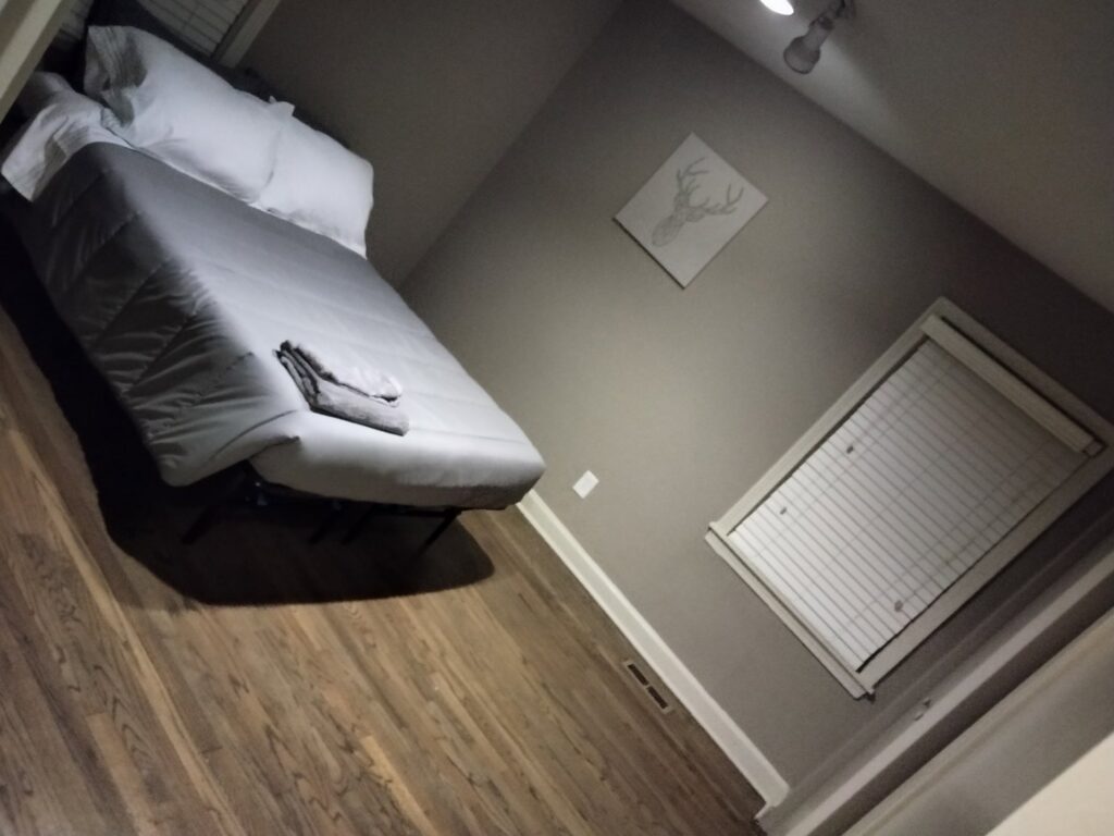 A neatly made bed in a clean bedroom, demonstrating the attention to detail by Perfection Cleaning in Kansas City, MO.
