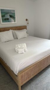 A neatly made bed with fresh, folded towels, showcasing the meticulous service of Vidal Cleaning in North Charleston, SC.