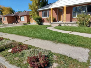 A neatly maintained residential lawn and landscaping, showcasing the quality work of Atkinson Lawn Care Service in Salt Lake City, UT.