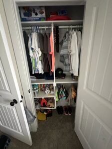 A neatly organized closet with clothes hung and items tidily arranged, showcasing organization services by Groove-By-Nature Cleaning in Idaho Falls, ID.