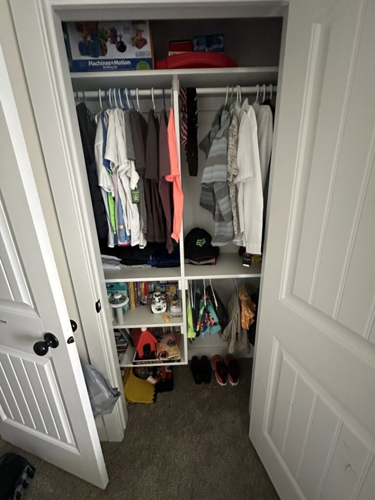 A neatly organized closet with clothes hung and items tidily arranged, showcasing organization services by Groove-By-Nature Cleaning in Idaho Falls, ID.