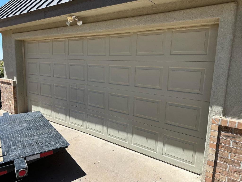 A new beige panel garage door recently installed by Espada Garage Door and Gate, LLC for a client in Las Cruces, NM.