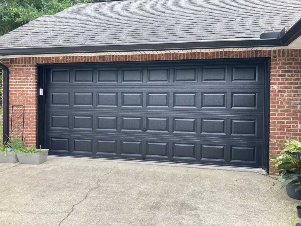 A newly installed black residential garage door by Jonathan at Verge Entrance Solutions/Overhead Door in Hattiesburg, MS.
