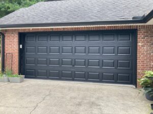 A newly installed black residential garage door by Jonathan at Verge Entrance Solutions/Overhead Door in Hattiesburg, MS.