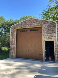A newly installed brown residential garage door by Jonathan at Verge Entrance Solutions/Overhead Door in Hattiesburg, MS.