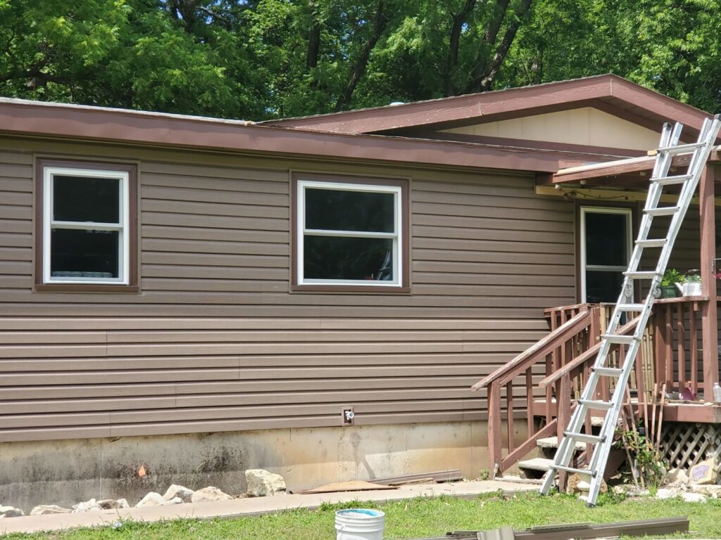 A residential home with new brown siding installed by River City Exteriors in San Antonio, TX