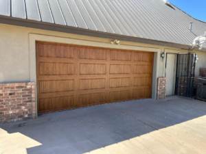 A beautiful new brown wood-look garage door installed by Espada Garage Door and Gate, LLC in Las Cruces, NM.