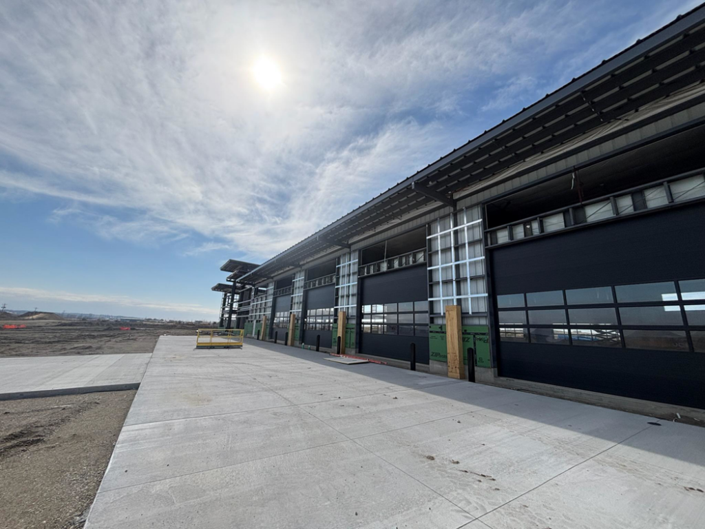 Newly installed commercial garage doors on a modern building by Garage Door Services, Inc. in Omaha, NE.