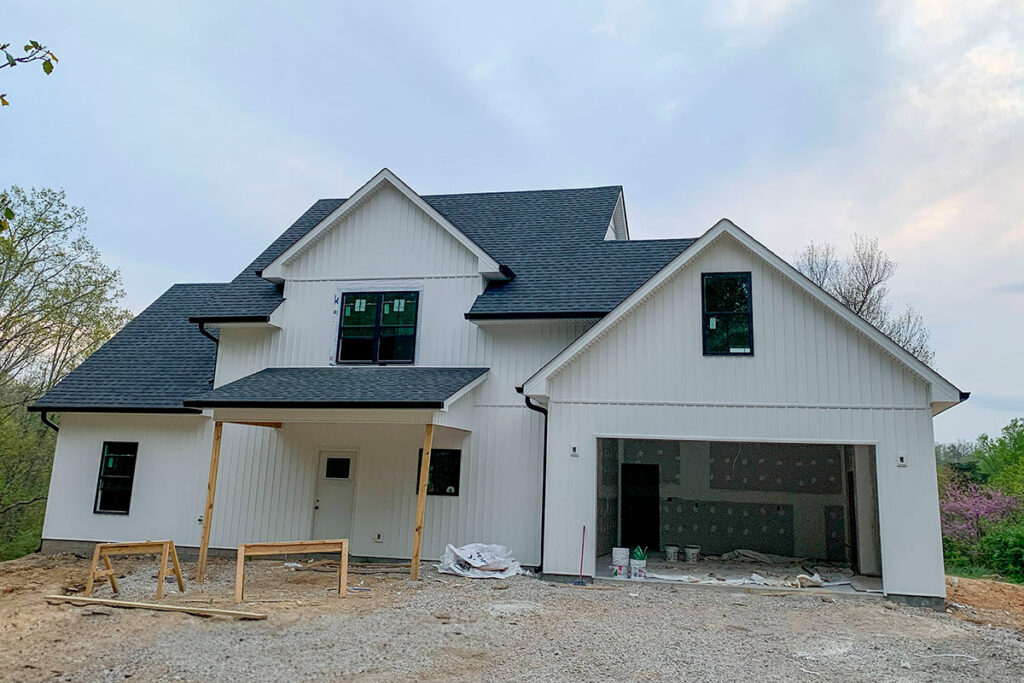 A new construction home featuring modern white vertical and horizontal siding by Ideal Siding Winston-Salem, NC.