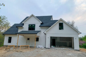 A new construction home featuring modern white vertical and horizontal siding by Ideal Siding Winston-Salem, NC.