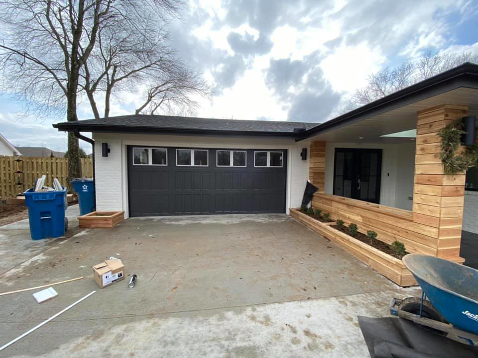 A newly installed dark gray garage door on a modern home, showcasing the quality work of Garage Door Medic, LLC in Rogers, AR.