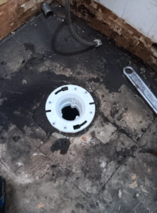 A new floor drain being installed during water damage repair by Integrity Solutions in Omaha, NE.