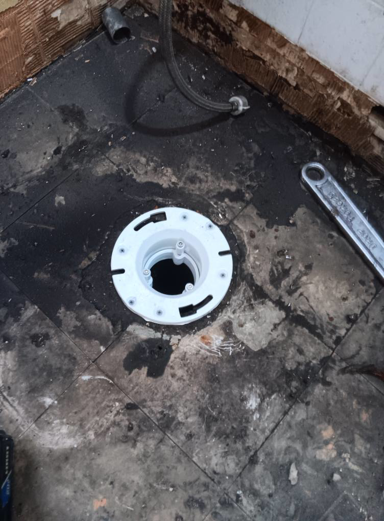 A new floor drain being installed during water damage repair by Integrity Solutions in Omaha, NE.