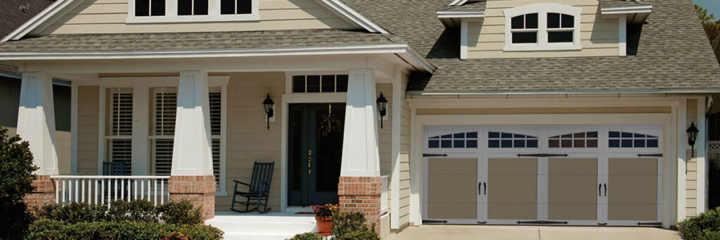 A newly installed tan and white garage door with decorative windows on a modern home by ALCAL Specialty Contracting Reno Sparks in Sparks, NV.
