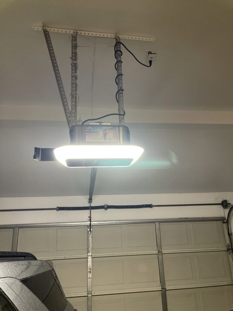 A newly installed garage door opener with integrated lighting, showcasing a completed job by Carmichael Garage Door in Carmichael, CA.