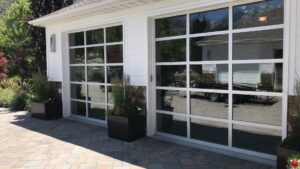 New glass garage doors installed on a residential property by Up N Over Garage Doors LLC in Layton, UT.