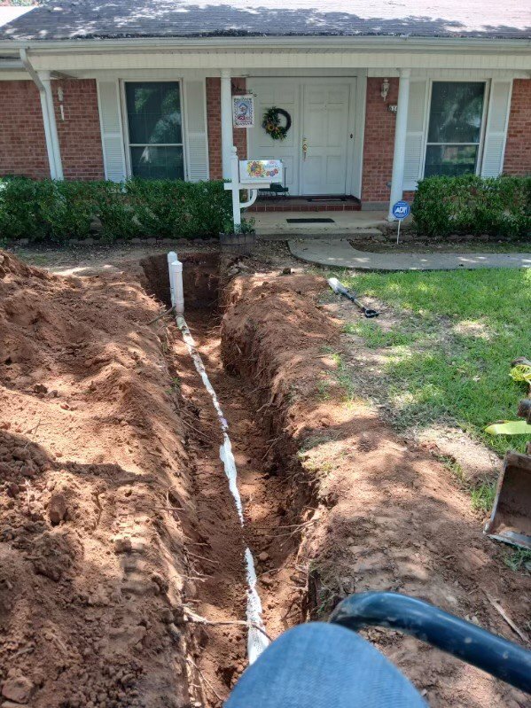 A new pipe being installed in a trench for water line repair by Robert Brown Plumbing, LLC in Bossier City, LA.