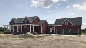A newly constructed house featuring vibrant red siding installed by Cordell Exteriors Inc in Chesapeake, VA