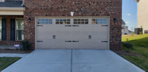 A newly installed residential garage door with windows by Action Garage Door in Jacksonville, AR.