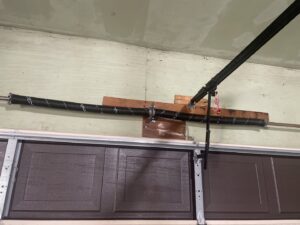 Newly installed torsion spring system above a brown residential garage door by Right Choice Doors in Layton, UT.