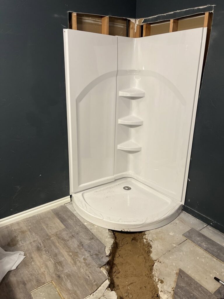 New shower stall installation during a water damage restoration project by Hull Plumbing, Inc. in Oklahoma City, OK.